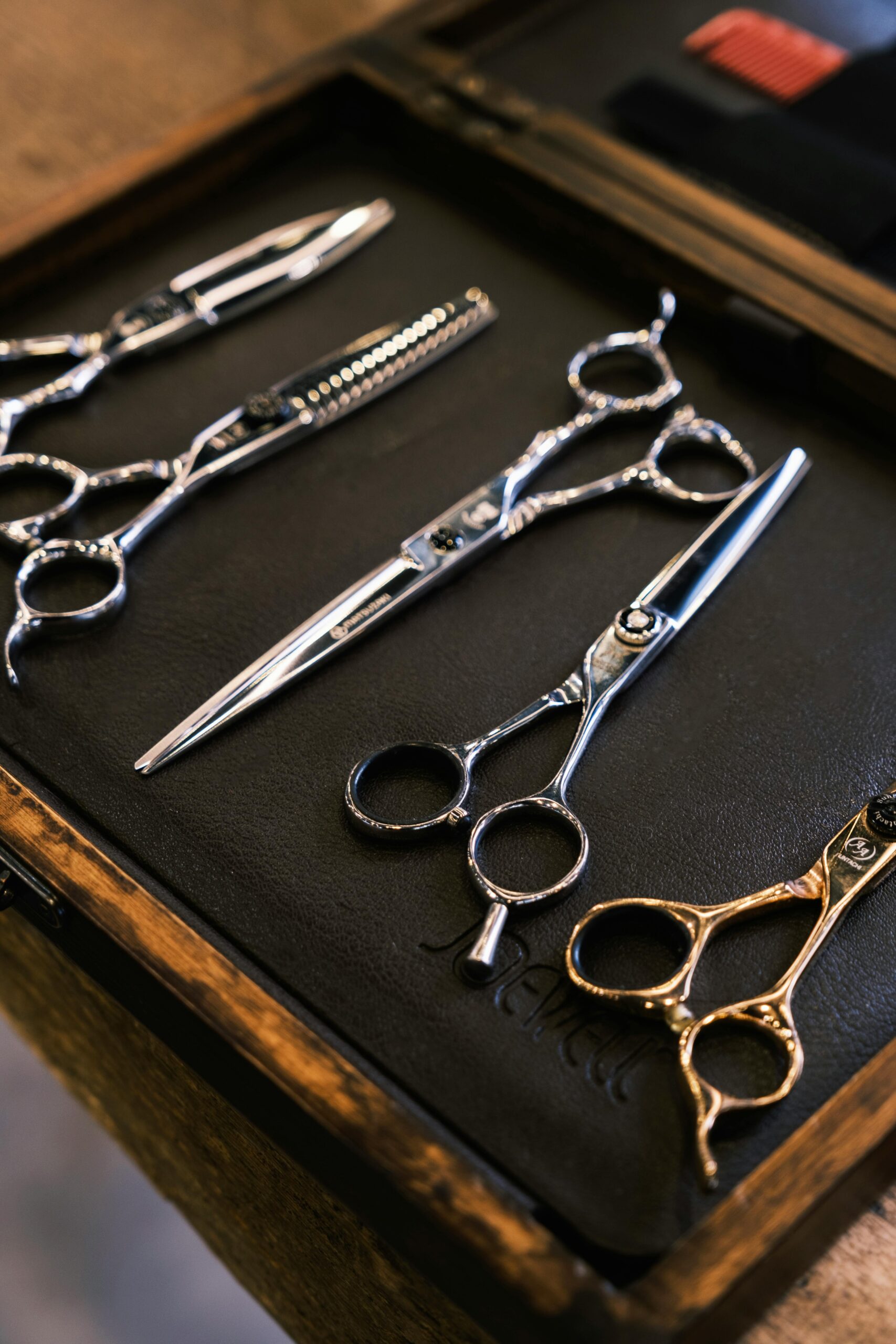 Close-up view of professional hair styling scissors set arranged in a case, perfect for salon use.
